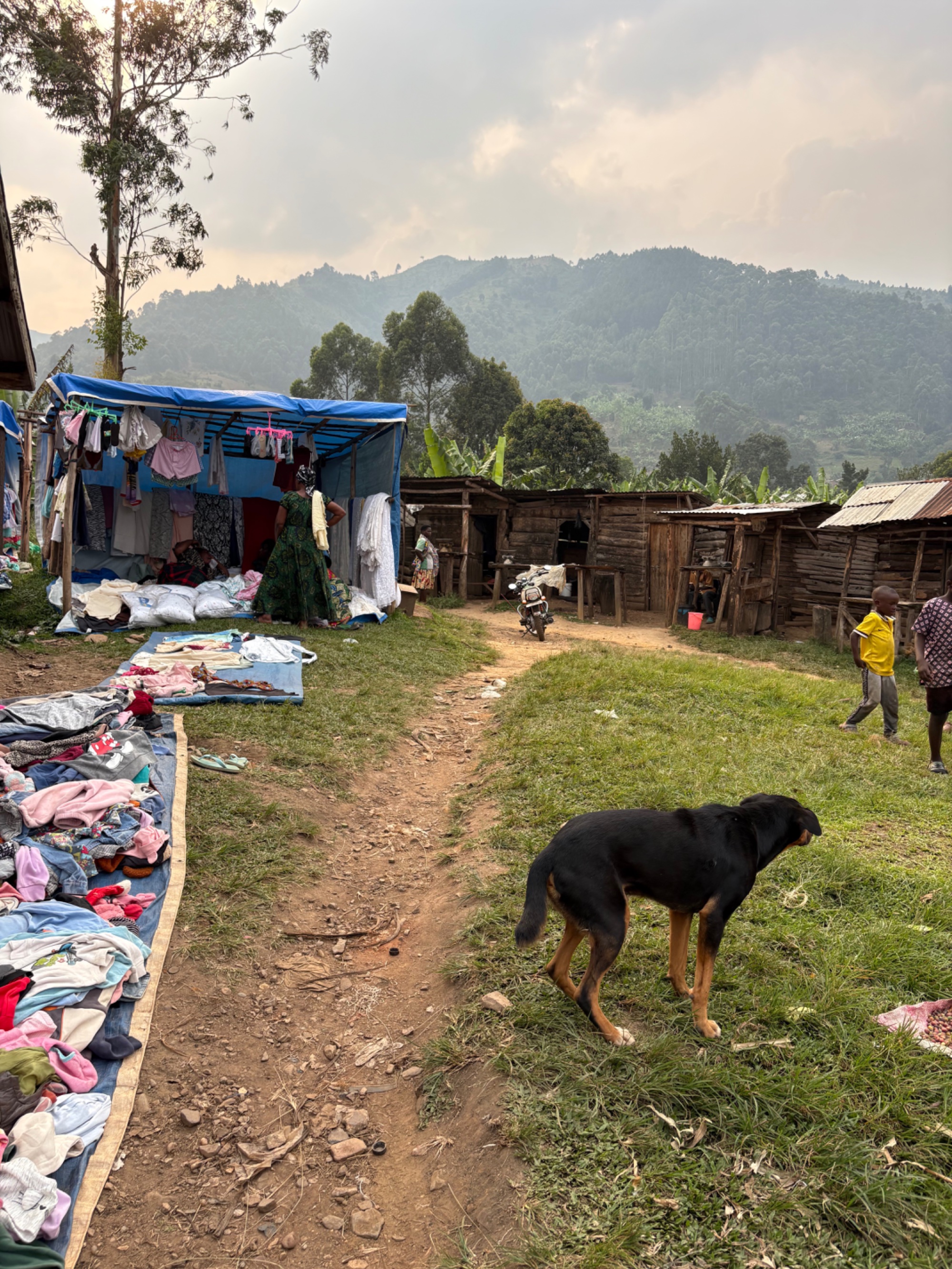 Daily life at the local market in Buhoma, Uganda — clothing and household goods