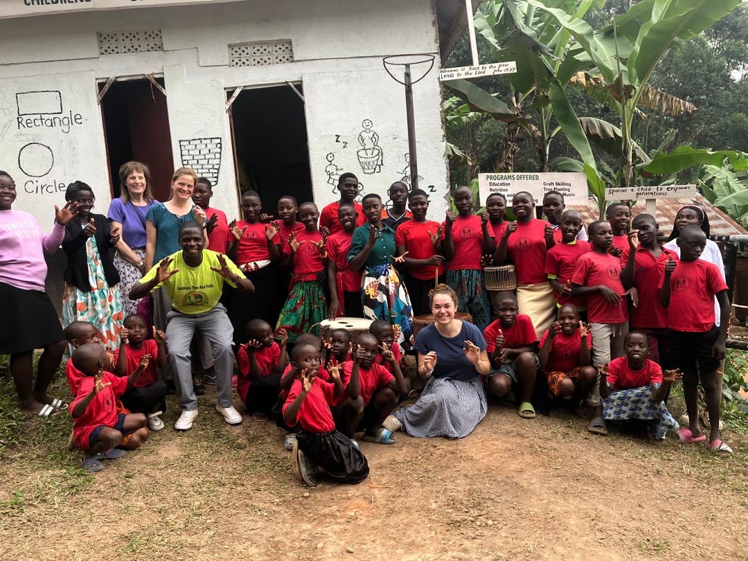 Group photo with children and visitors at the Bwindi Orphan Children's Support Project in Buhoma, Uganda