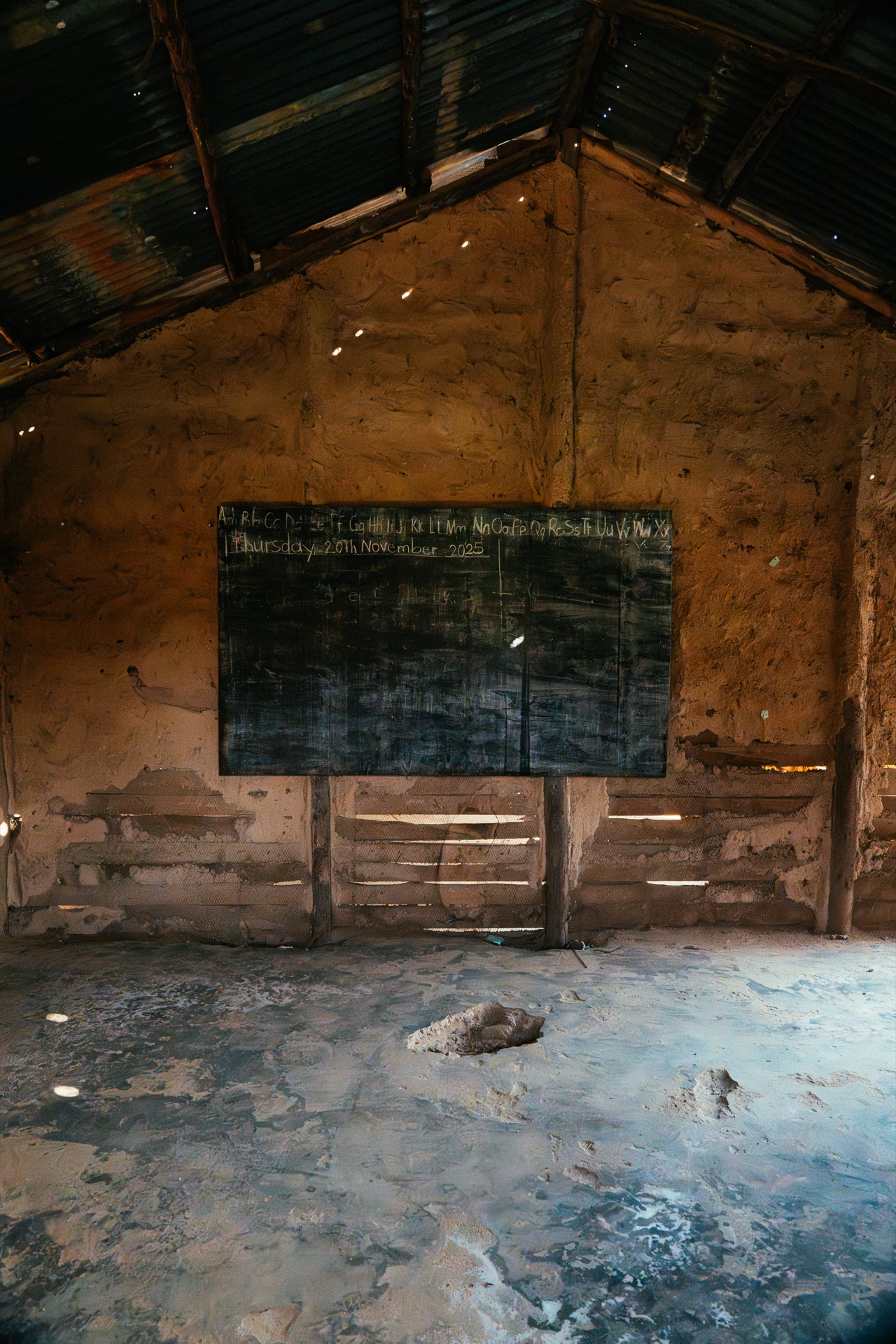 A rural classroom in Buhoma – sparse, with mud walls and a tin roof