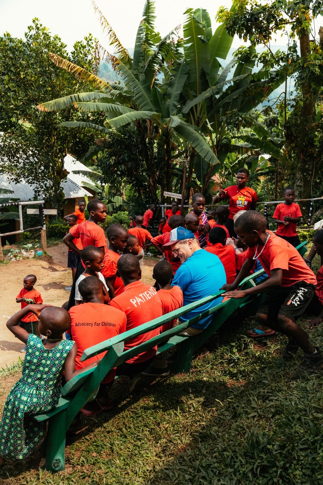 Mark surrounded by children at HopeKitchen Buhoma near Bwindi, Uganda