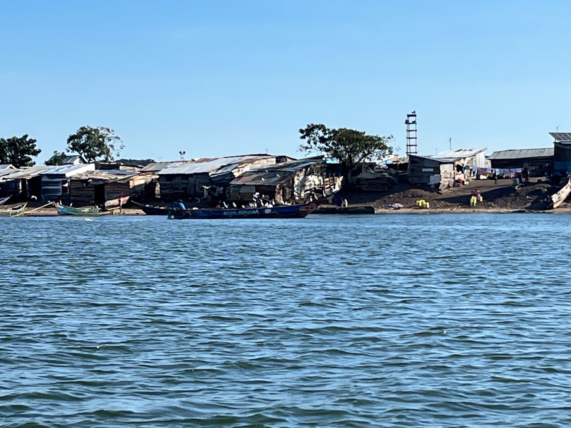Fishing village on an island in Lake Victoria, Uganda, with boats moored along the shore