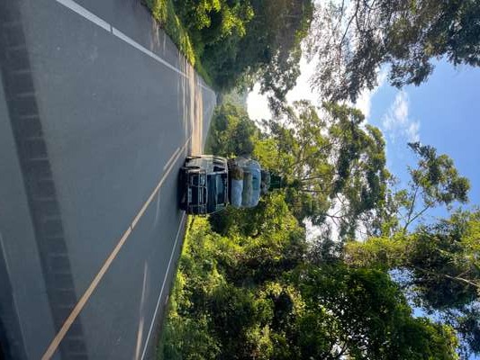 Heavily loaded truck on a Ugandan highway surrounded by green vegetation